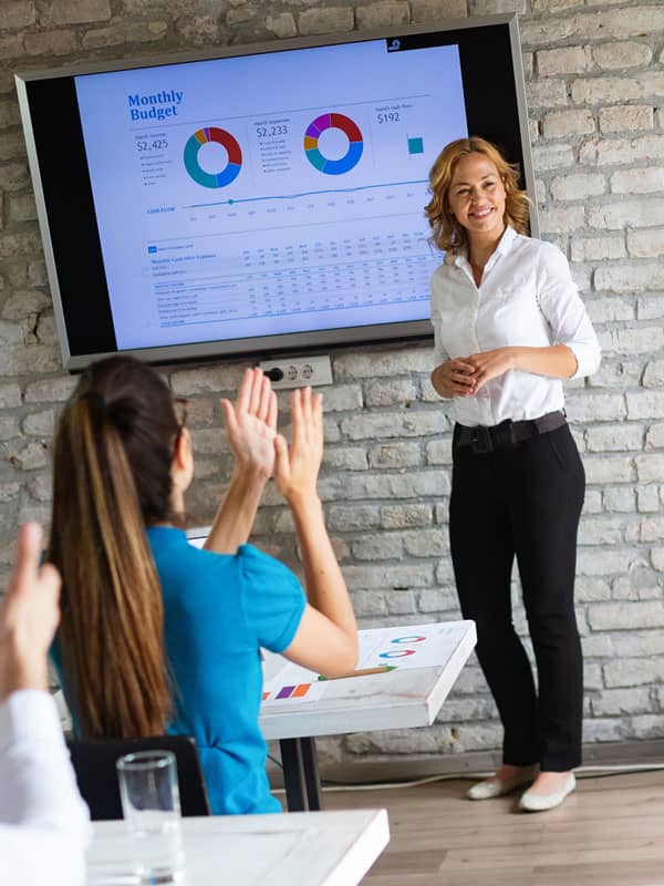 woman teaching budget in classroom